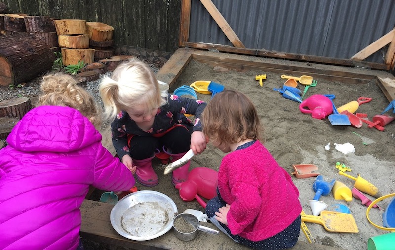 preschool children playing in sandbox